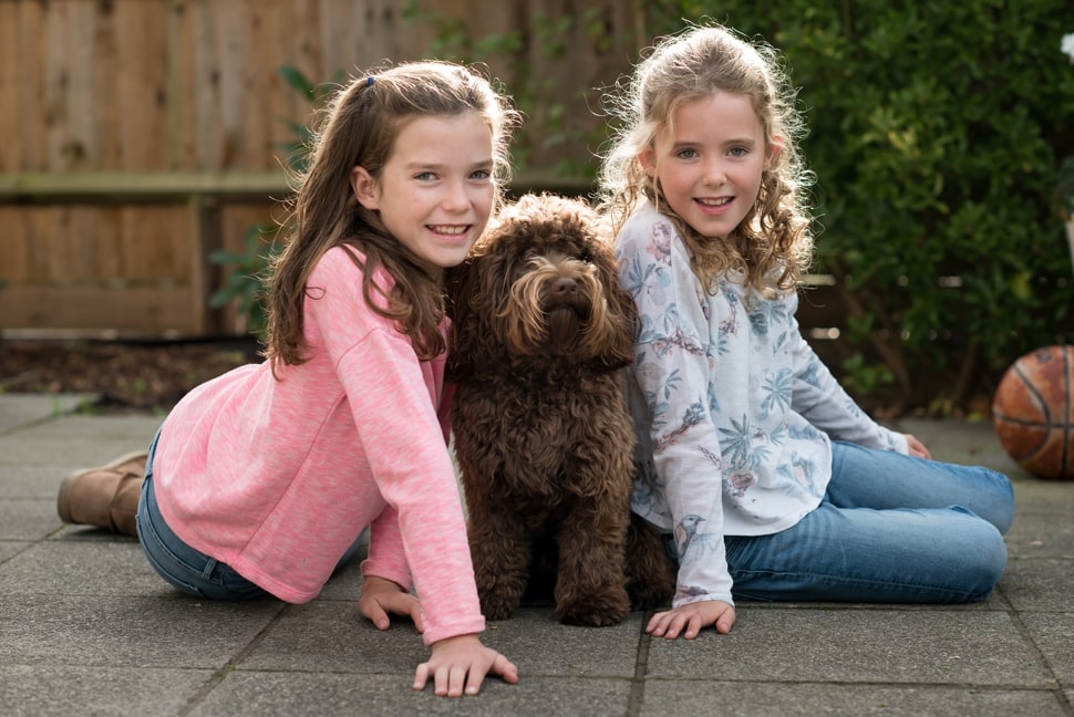 sisterly photo with family dog, Day in the life photo sessionr, London family photographer