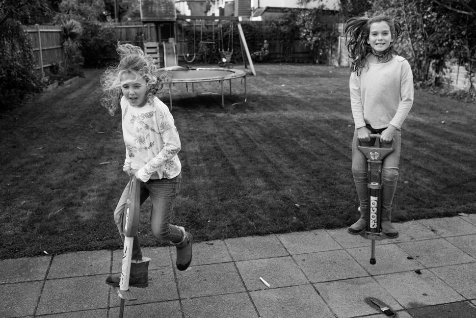 two girls on pogo sticks during Day In The Life photoshoot