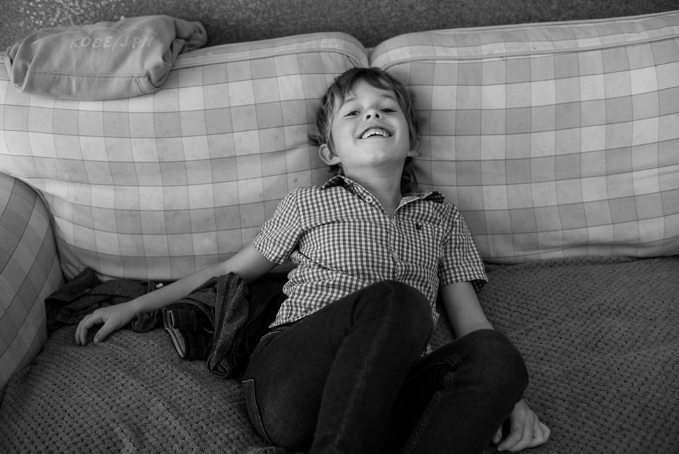boy chilling on the sofa at home during family photo shoot