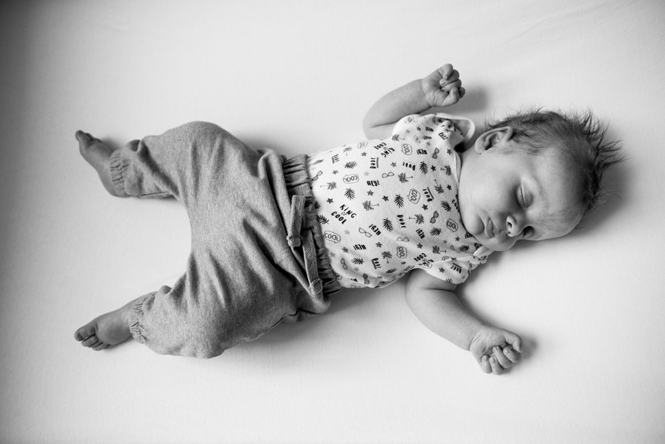 newborn baby sleeping during family photo session