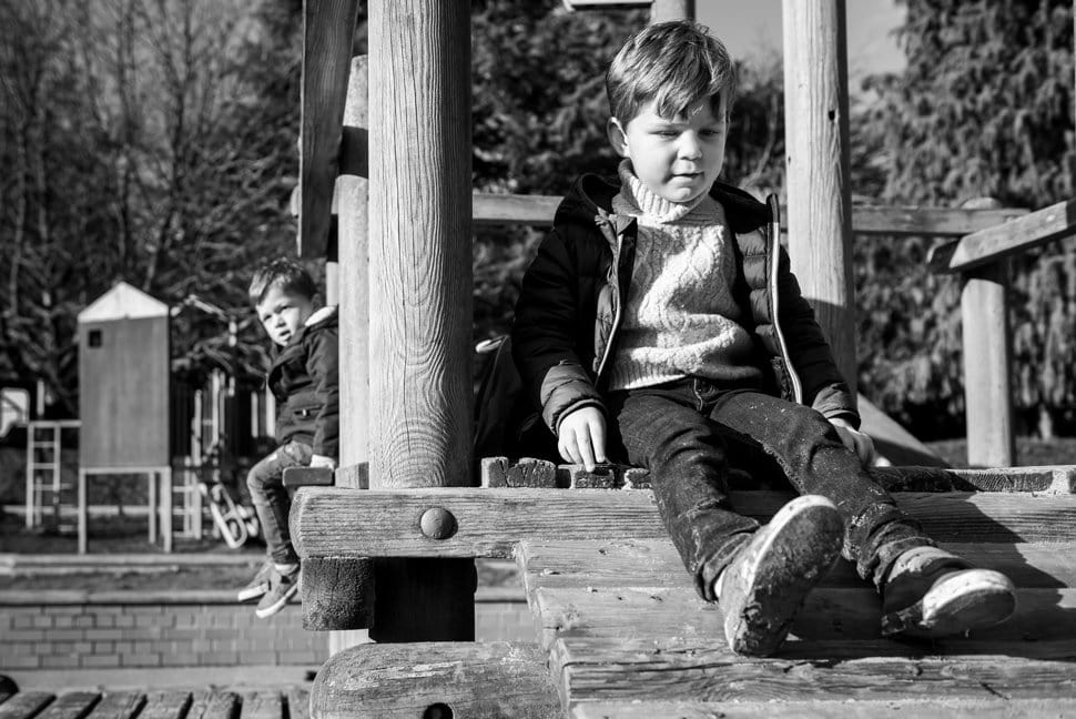 two brothers playing on wooden climbing frame in Clarence Park, St Albans