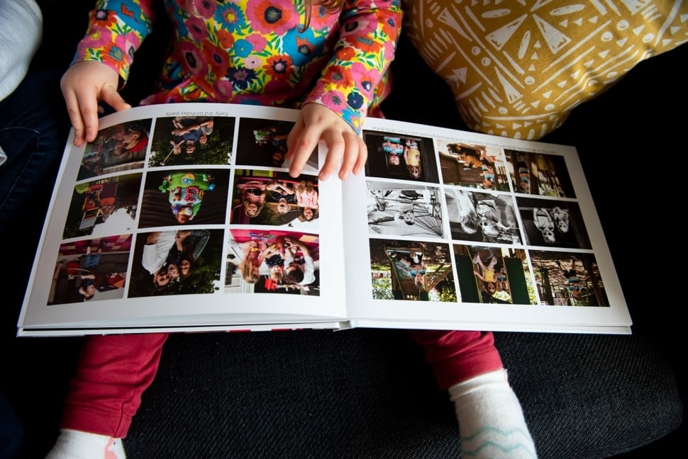 child looking at family photo album