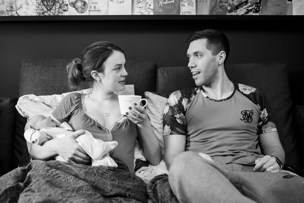 new parents enjoy cup of tea post home birth