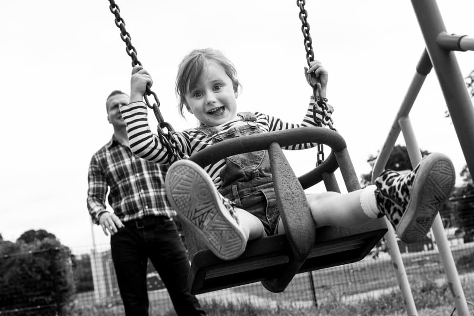 happy girl on swing in St Albans park