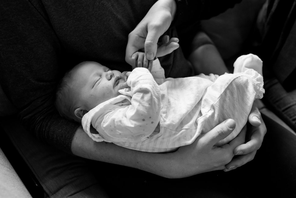 newborn photoshoot showing baby girl at home