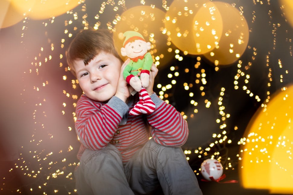 boy with elf and christmas twinkly lights