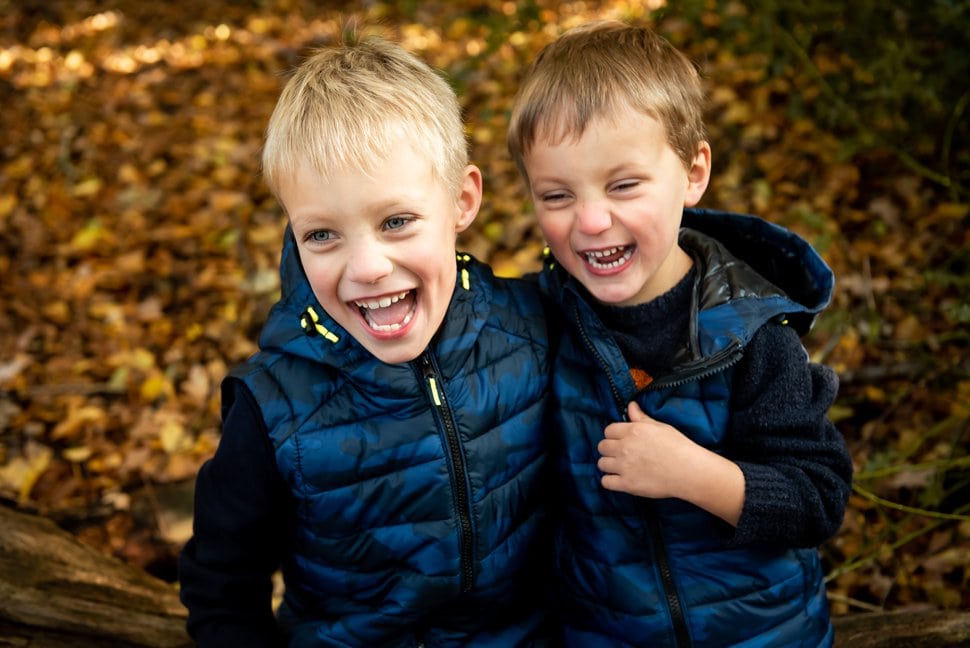 laughing brothers in the autumn woods