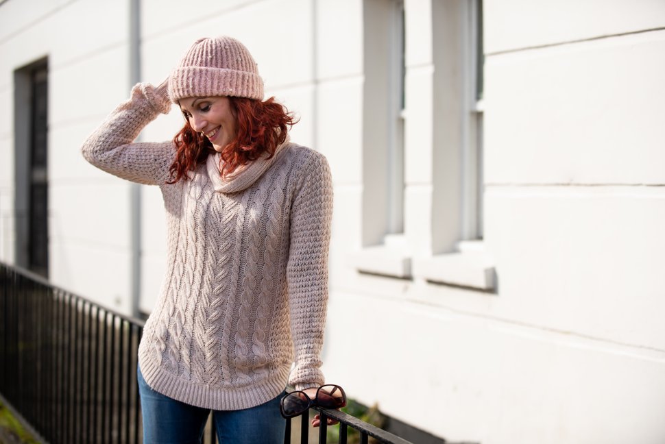 laughing girl in cable knit jumper and hat during corporate shoot