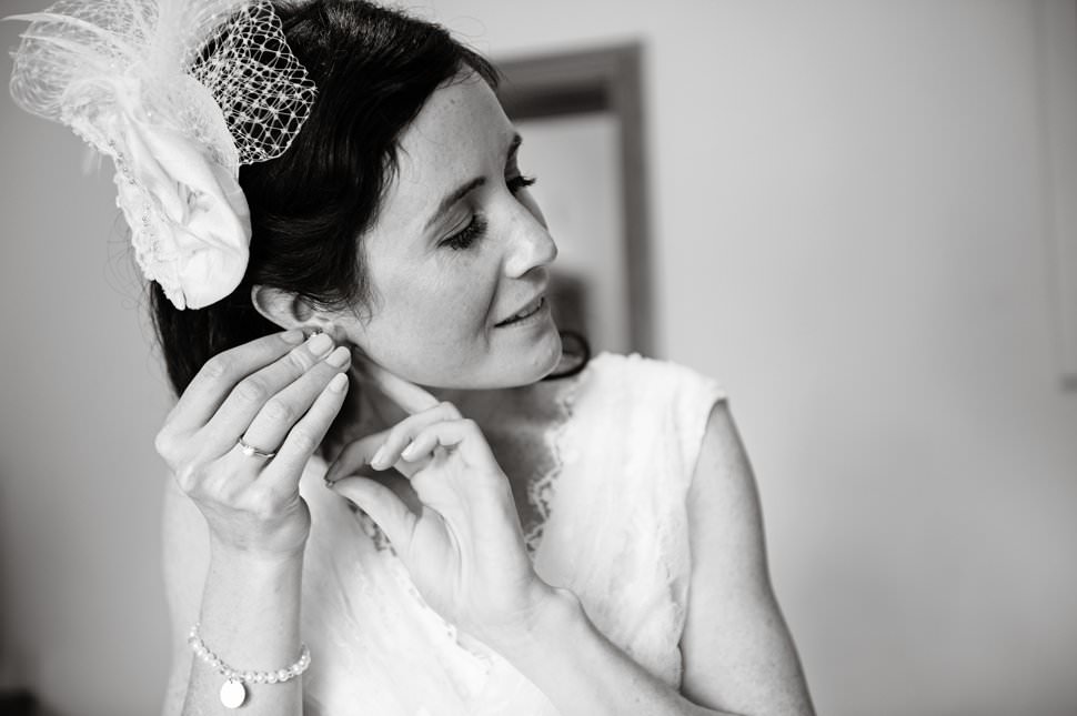 St Albans bride putting on earrings