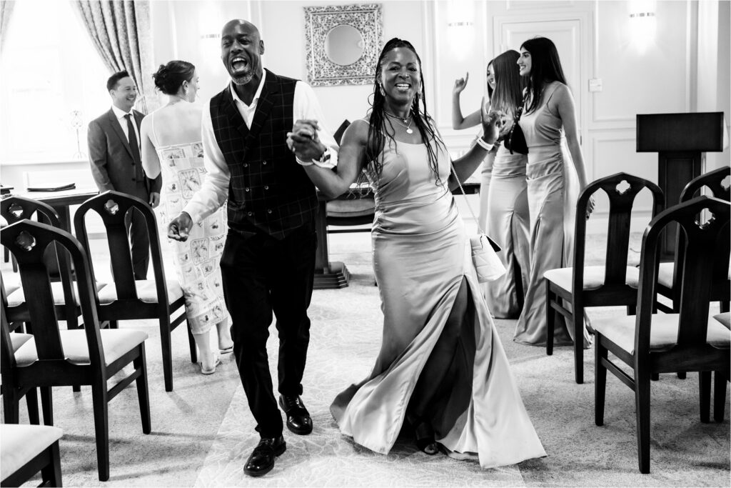 Best man and maid of honour dance back down the aisle at micro register office wedding