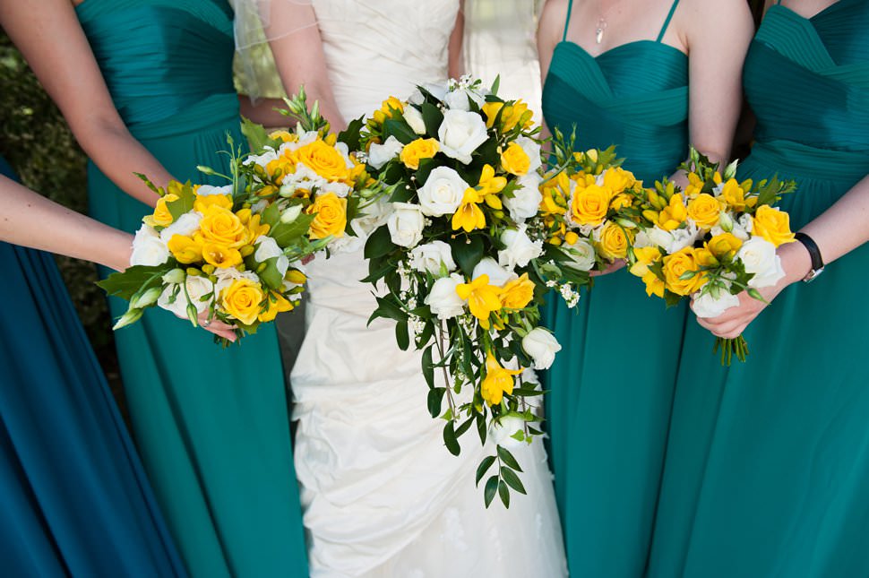 bride with bridesmaids wearing green dresses