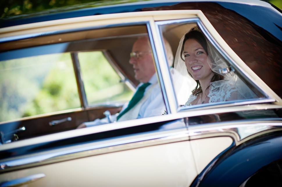 bride in classic wedding car