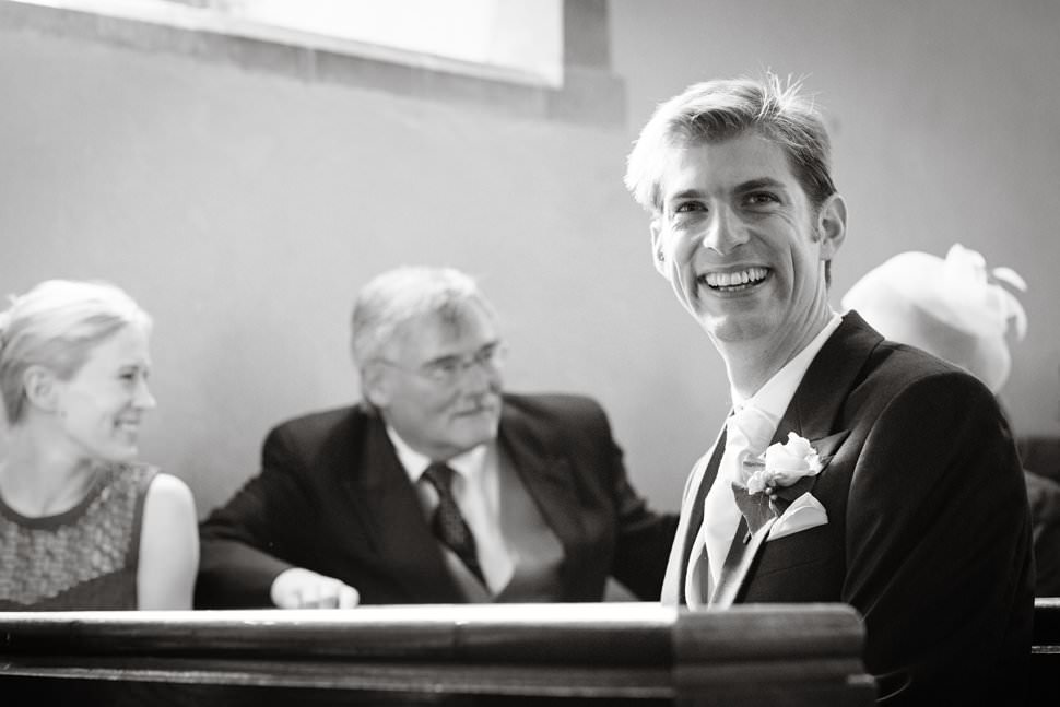 happy groom waiting at hertfordshire church