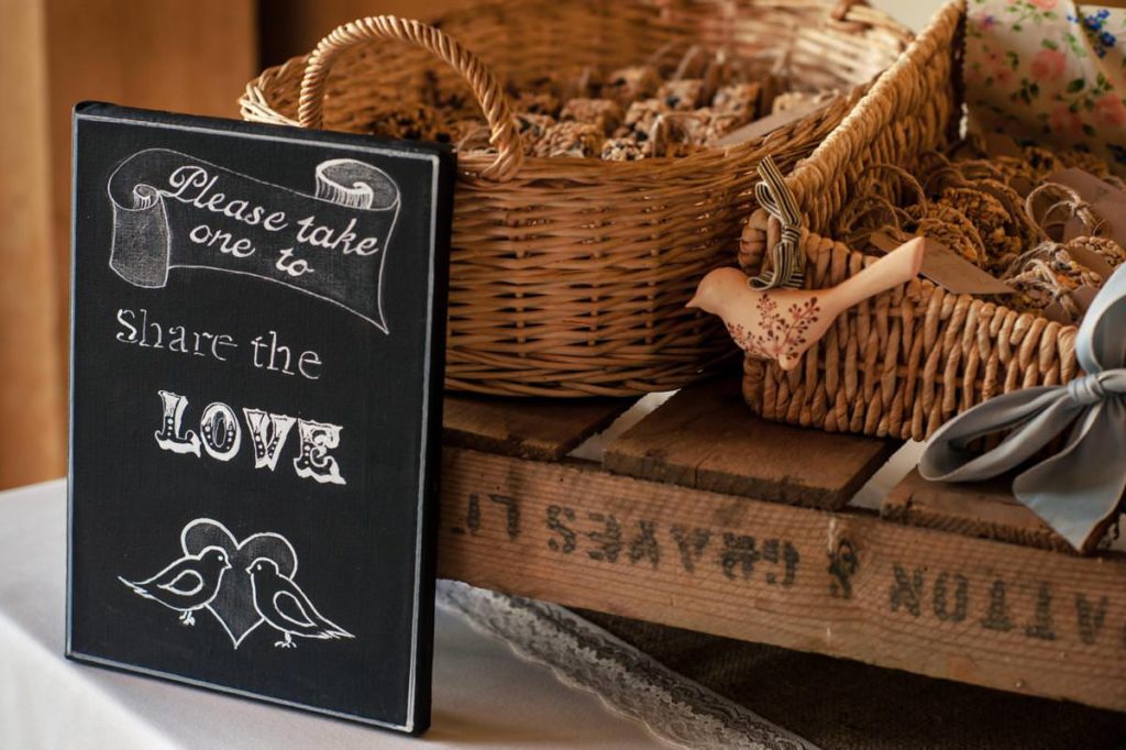Bird seed hangers with sign as a wedding favour idea