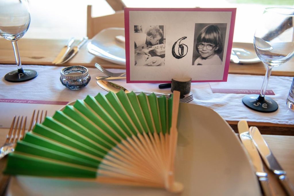 Wedding place setting with green paper fan for hot weather