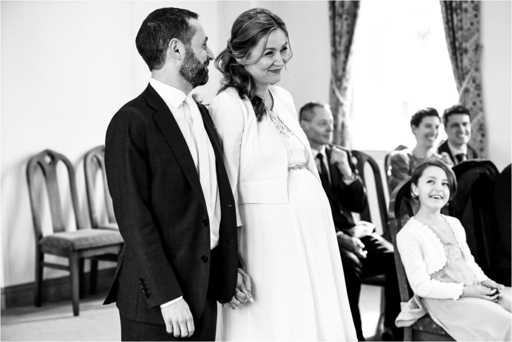 Smiling bride and groom during St Albans Registry Office wedding ceremony.