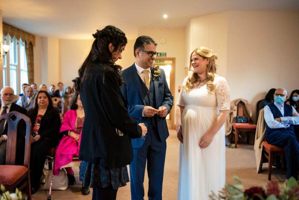 Daughter of the groom gives the couple their wedding rings at St Albans Registry Office.