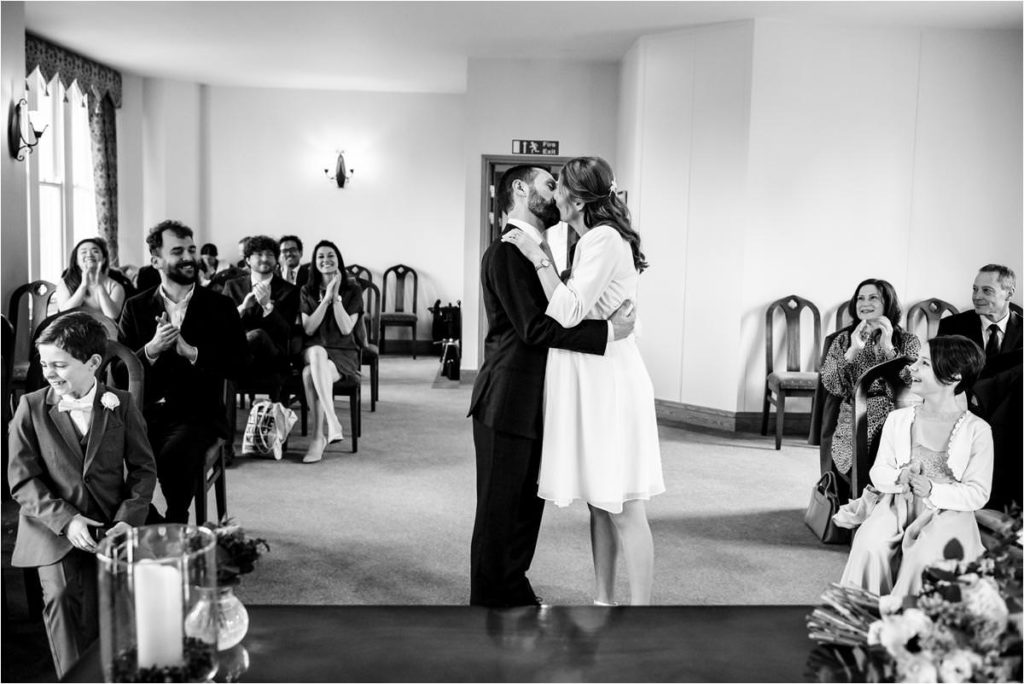 Bride and groom kiss during St Albans Registry Office wedding ceremony.