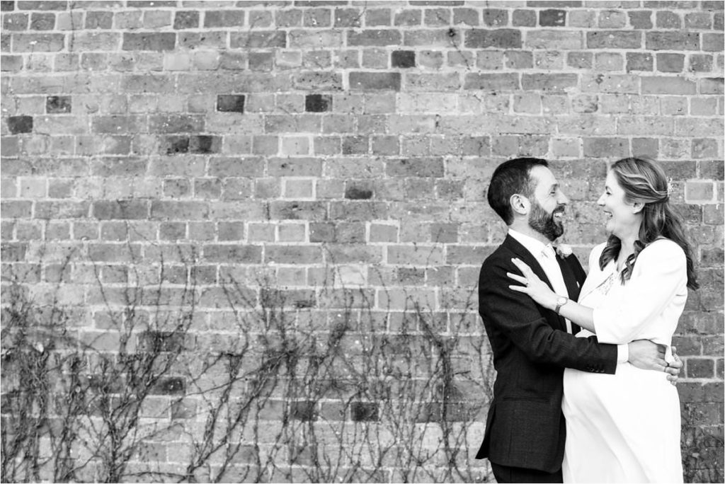 Bride and groom hug outside St Albans Registry Office