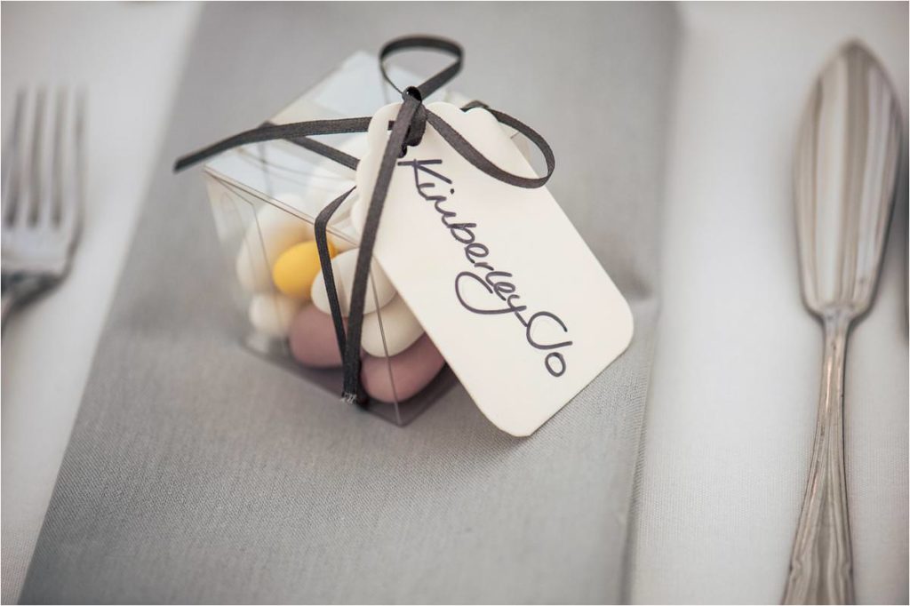Box of sugared almonds wedding favours on a grey linen napkin