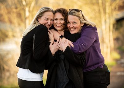 Three women embrace during branding shoot