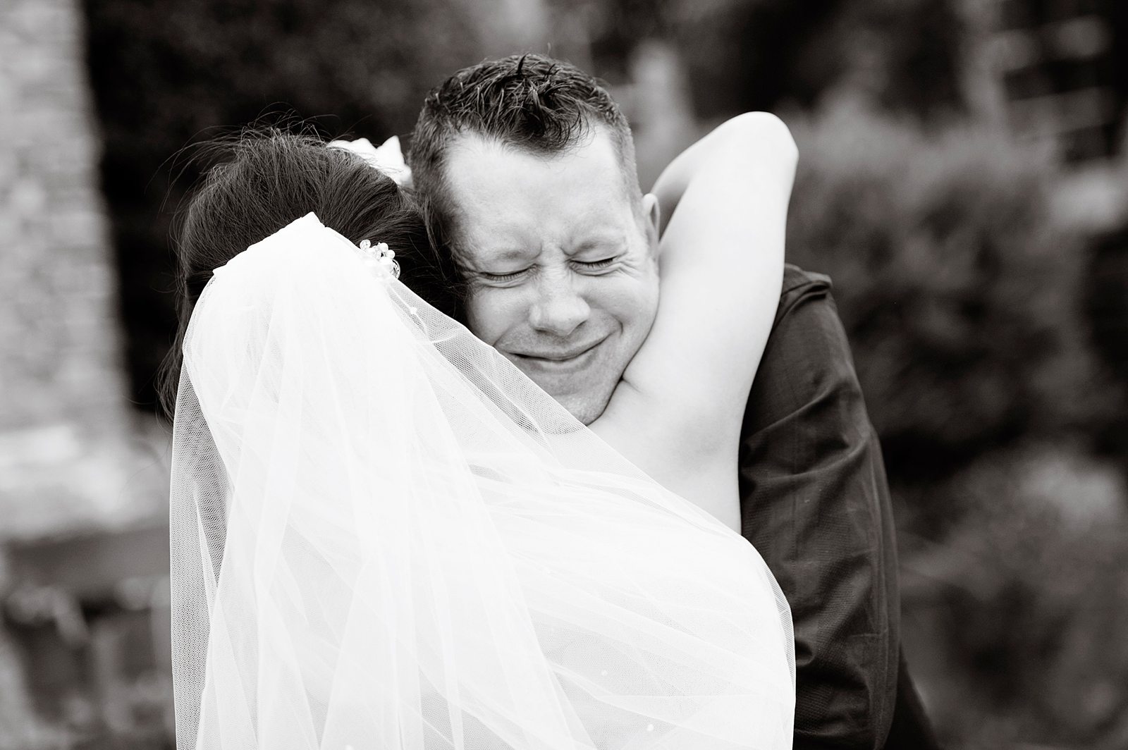 Bride and groom share emotional hug at Hertfordshire wedding