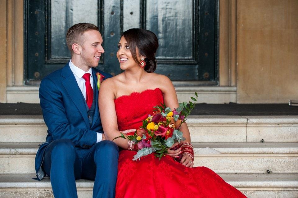 Syon Park wedding with bride in red wedding dress and Anglo-Indian fusion elements