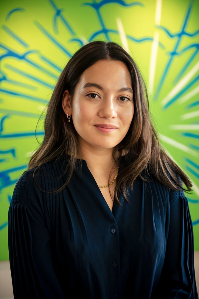 female headshot with a bright green background
