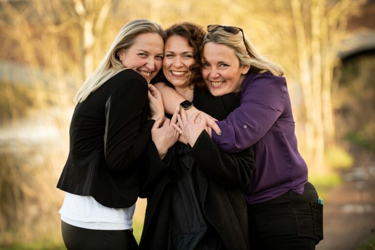 three hugging female colleagues during personal branding shoot