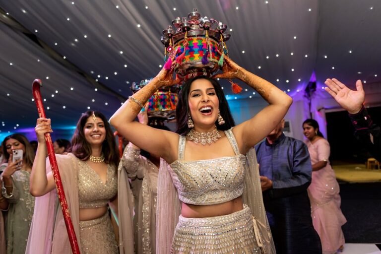 Bride to be enjoys dancing and singing at colourful sangeet at Luton Hoo walled garden