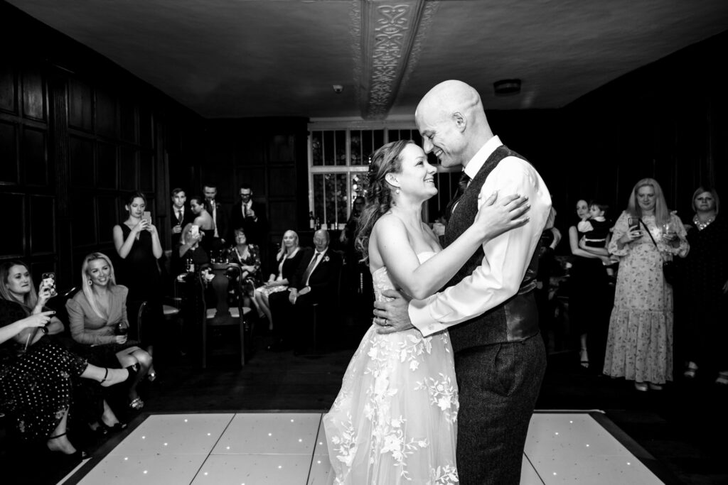 Black and white photo of bride and groom sharing first dance at Rothamsted Manor