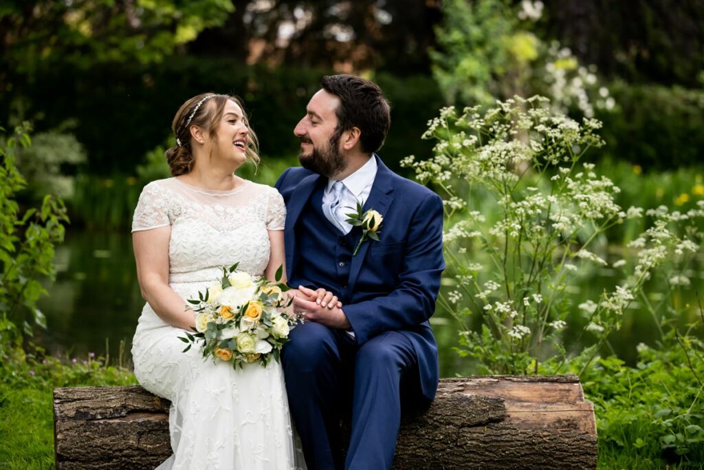 St Michaels Manor bride and groom sit in beautiful gardens