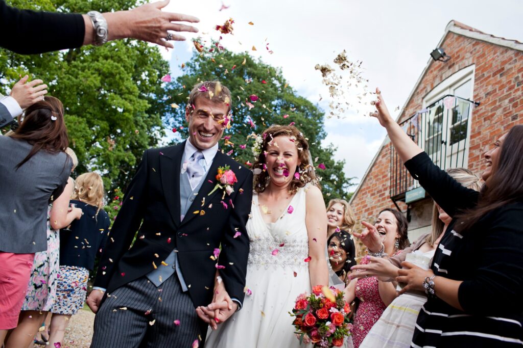 Bride and groom during confetti throw at Hertfordshire wedding