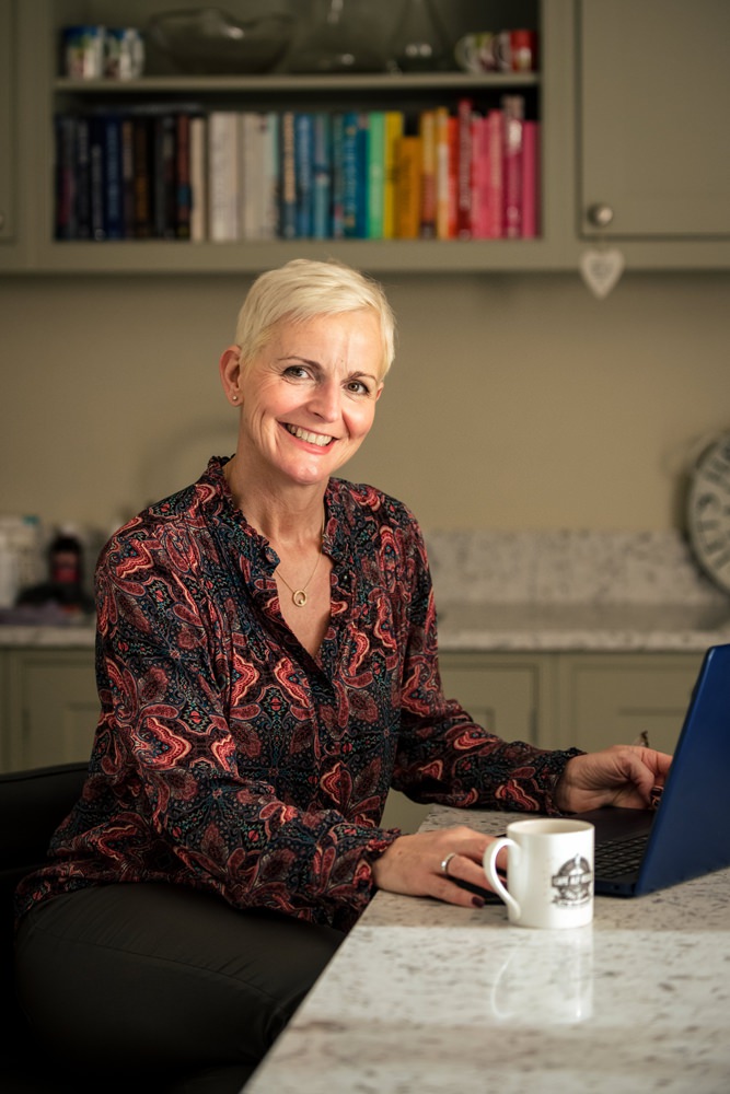 Personal stylist works on computer during St Albans personal branding shoot