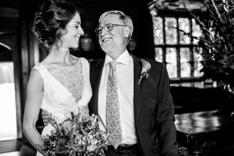 Dad and daughter share pre-wedding embrace and look lovingly at each other at Hertfordshire wedding