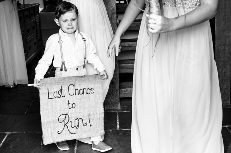 Crying page boy about to walk down aisle at Hertfordshire wedding