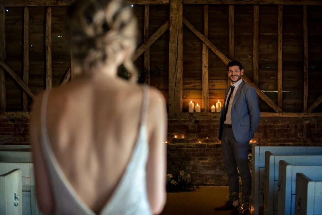 Groom waits at the top of the aisle at Milling Barn