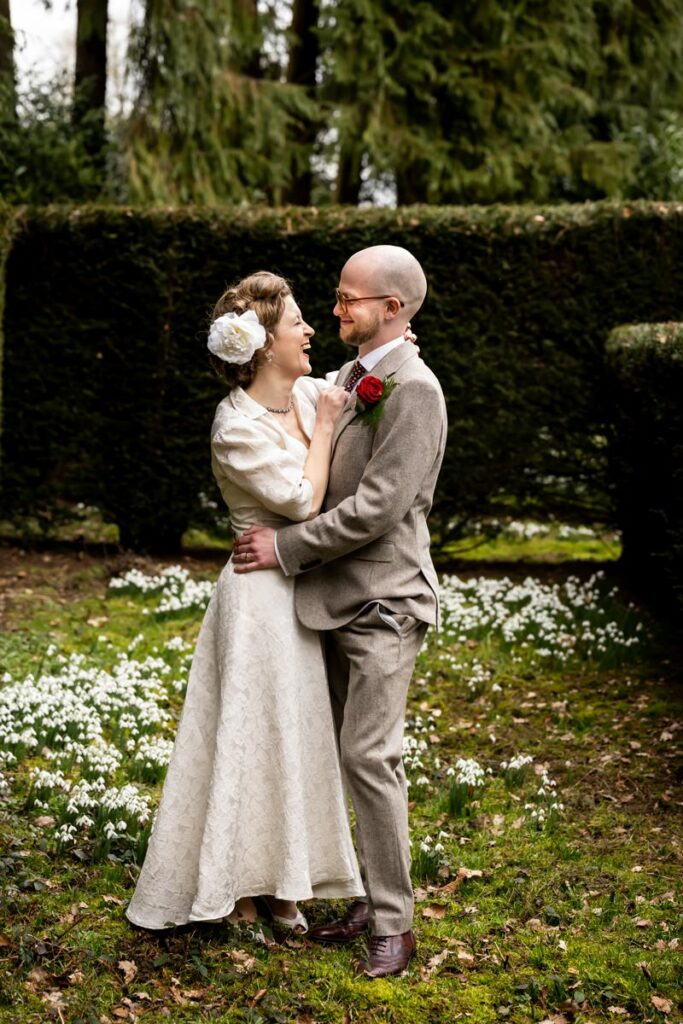 Bride and groom in spring snowdrops at Rothamsted Manor