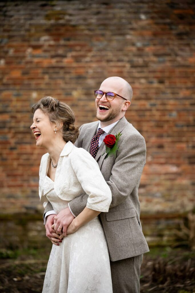 Laughing bride and groom outside of Rothamsted Manor