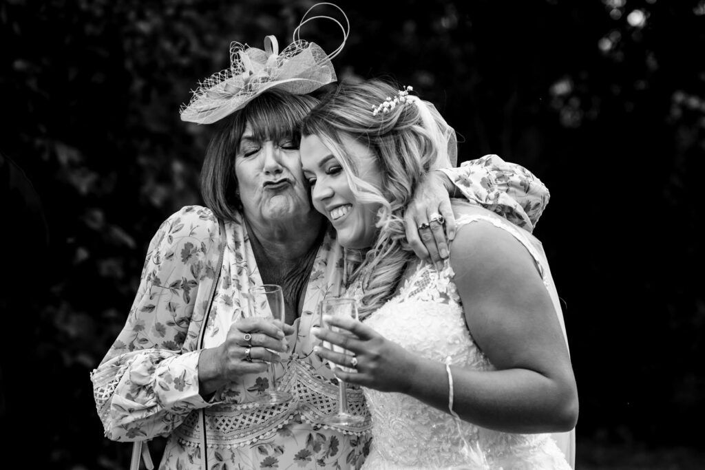 Bride and mother share squishy hug