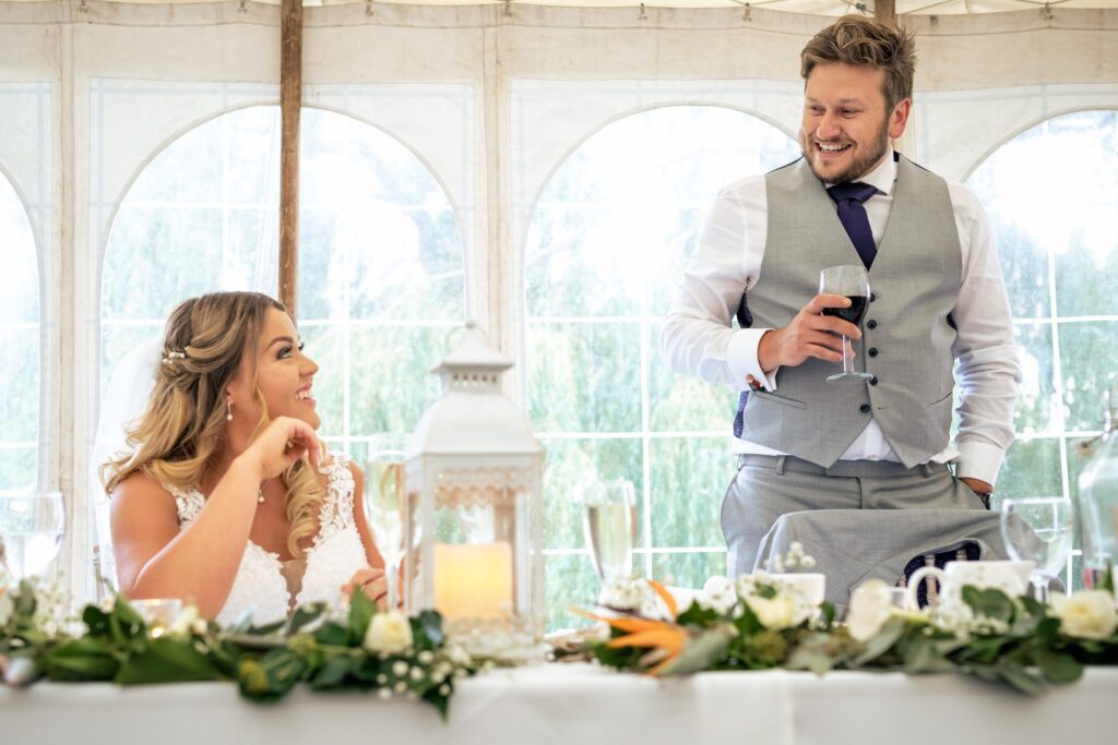 Groom toasts his new bride at marquee wedding at home