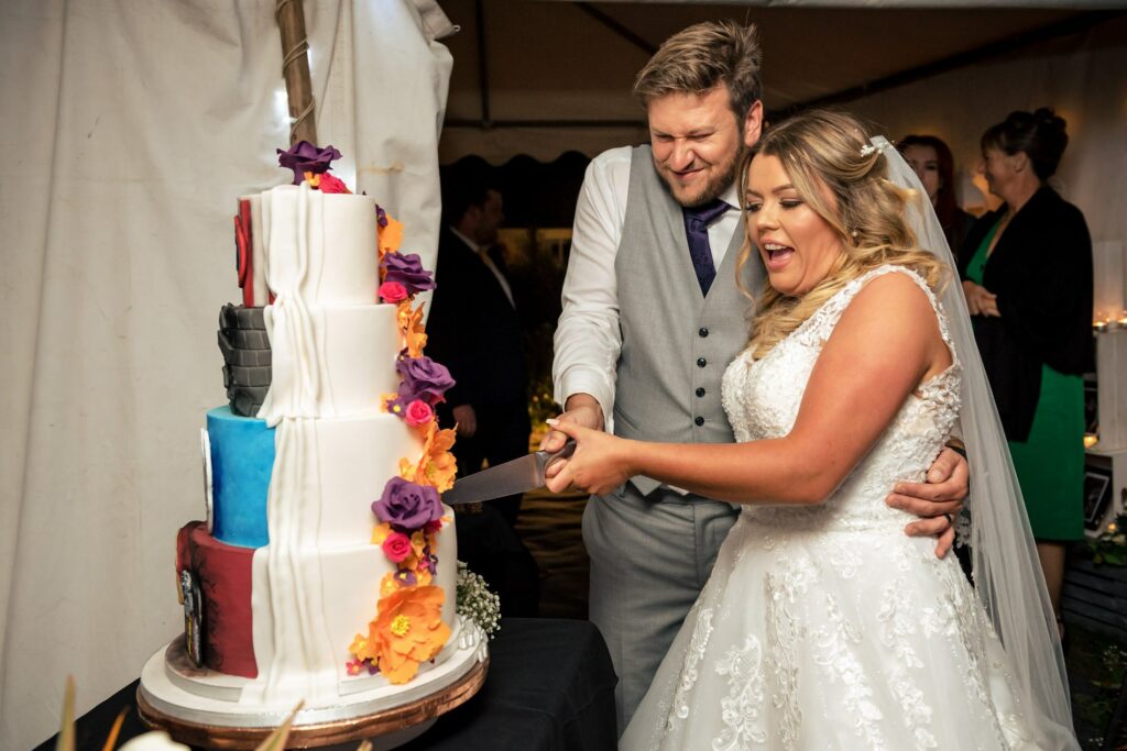 bride and groom cut superhero wedding cake