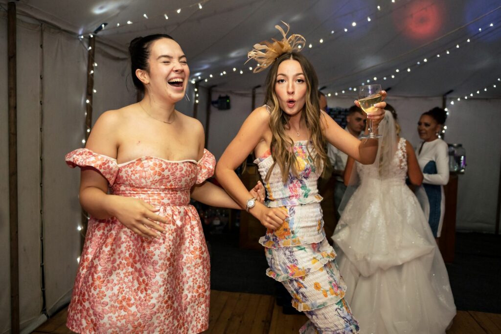 Happy wedding guests get into the dance floor