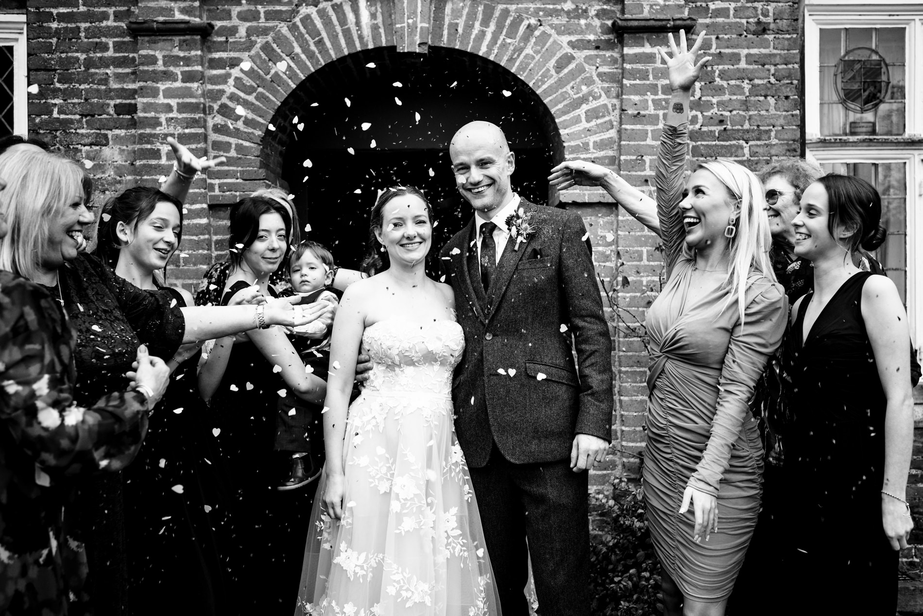 Couple in confetti toss outside country house