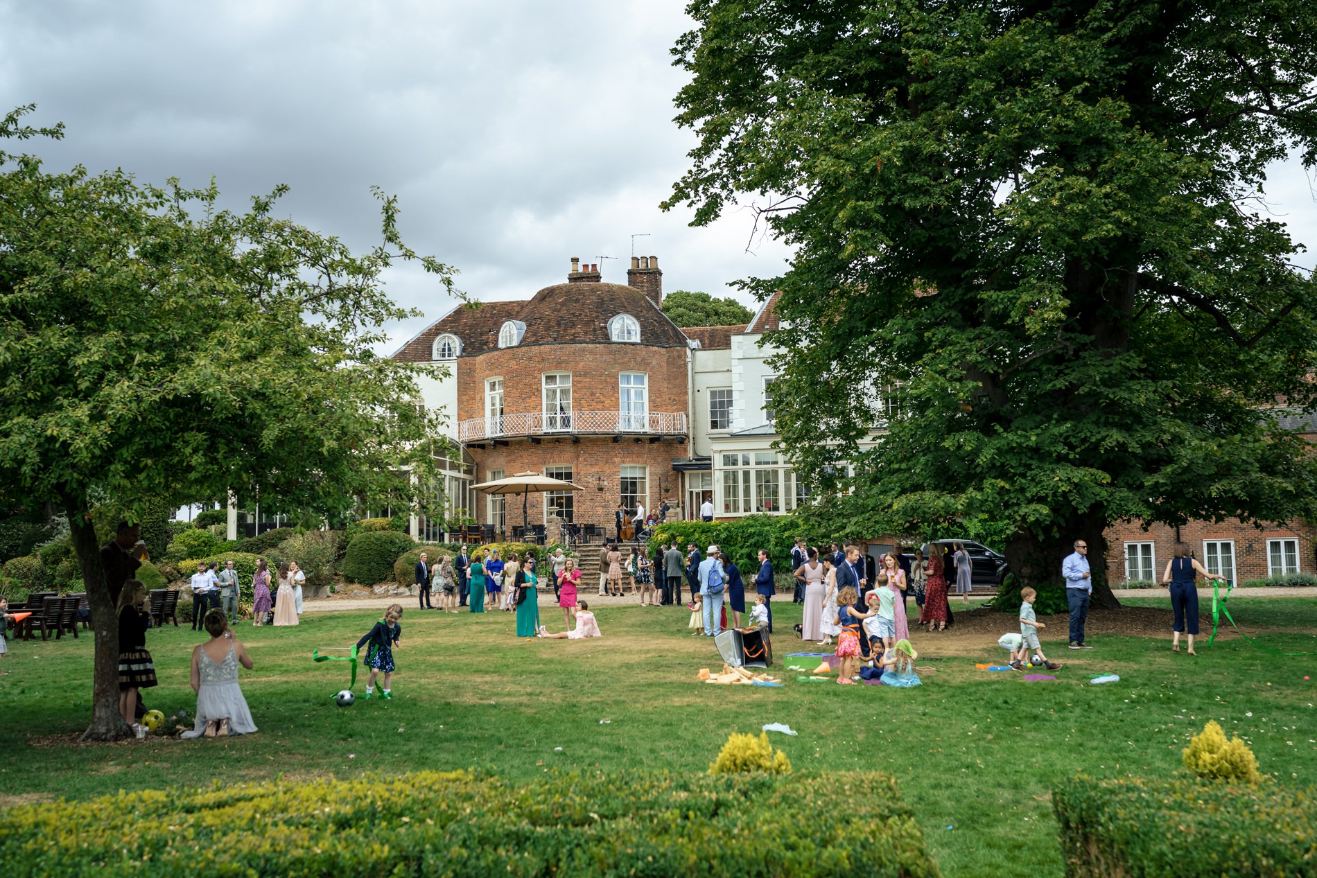 Wedding guests enjoy drinks and games on the lawn at St Michaels Manor Hotel