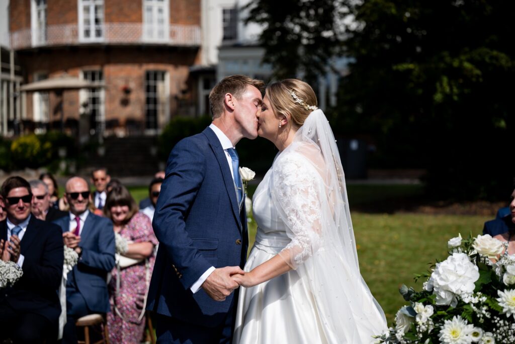 Bride and groom share first kiss at St Michaels Manor wedding