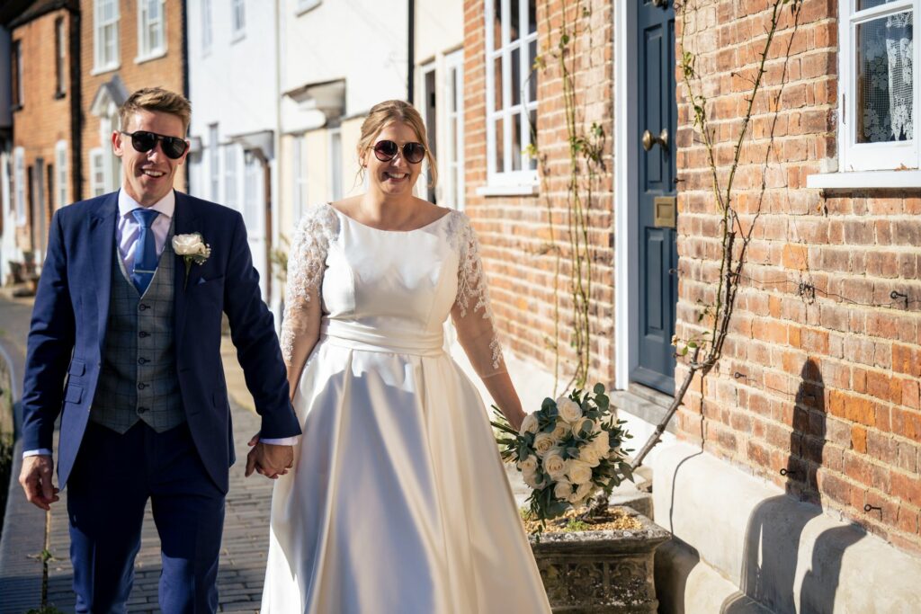 Bride and groom wearing sunglasses during couple portraits on Fishpool Street in St Albans