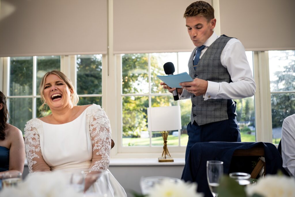 Bride laughs at grooms wedding speech at St Michaels Manor