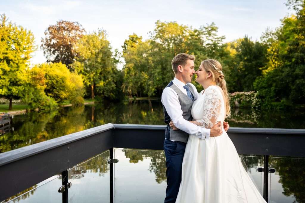 Bride and groom in front of St Michaels Manor lake