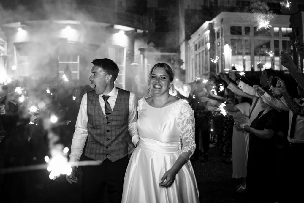 Bride and groom have a smokey sparkler exit from St Michaels Manor